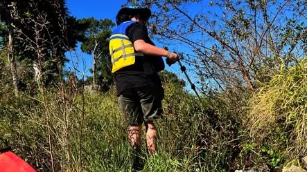 Kayaks on the water collecting debris